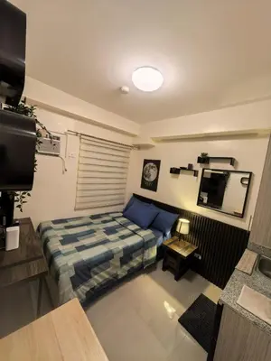 a bedroom with a bed and a tv in a room at FSZAirbnb in Manila