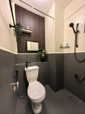 a bathroom with a toilet and a shower at FSZAirbnb in Manila