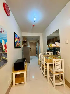 a kitchen and dining room with a table and chairs at D'Annes Holistay in Manila