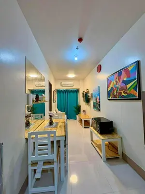 a kitchen with a table and chairs in a room at D'Annes Holistay in Manila