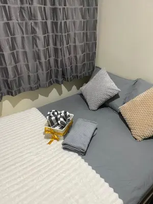 a bed with two pillows on top of it at The Cozy Nook in Manila