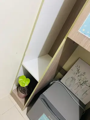 a room with a shelf with a plant in it at The Cozy Nook in Manila