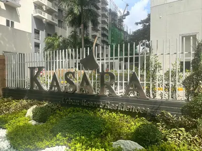 a sign in front of a white fence at Casa Doña at Kasara Urban Resort Residences in Manila