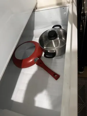 a red pot and a pan on a shelf at Casa Doña at Kasara Urban Resort Residences in Manila