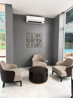 a living room with two chairs and a table at Casa Doña at Kasara Urban Resort Residences in Manila