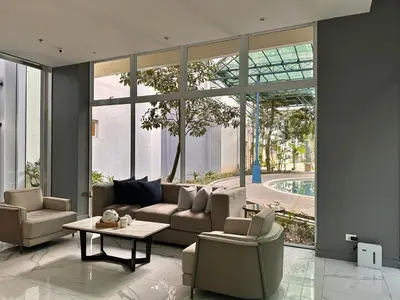 a living room with a couch and chairs and a table at Casa Doña at Kasara Urban Resort Residences in Manila