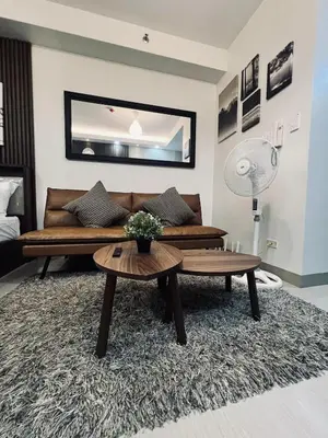 a living room with a couch and a table at The Baylight Escape at Shore 2 in Manila