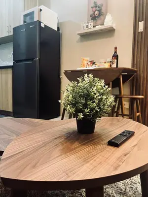 a table with a plant on top of it at The Baylight Escape at Shore 2 in Manila