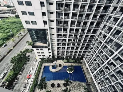 an overhead view of a large building with a swimming pool at The Baylight Escape at Shore 2 in Manila