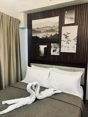 a swan made out of towels on a bed at The Baylight Escape at Shore 2 in Manila