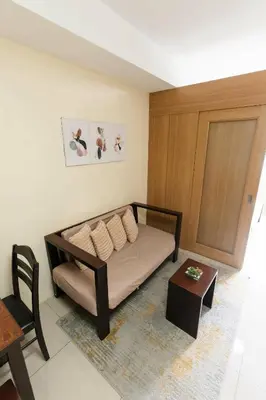 a room with a bed and a table and a door at shell residences condo walk to Mall of Asia in Manila