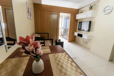 a living room with a vase of flowers on a table at shell residences condo walk to Mall of Asia in Manila