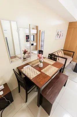 a dining room with a wooden table and chairs at shell residences condo walk to Mall of Asia in Manila
