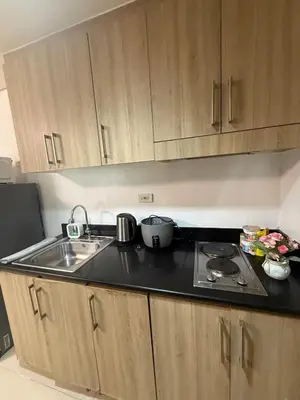 a kitchen with a sink and a counter top at City Elite Retreats at Shore in Manila