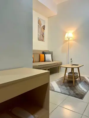 a living room with a couch and a table at Mandarin Suite Stay in Manila