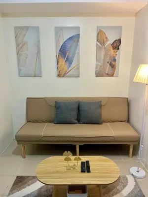 a living room with a couch and a coffee table at Mandarin Suite Stay in Manila