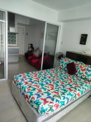 a bedroom with a large bed with a colorful comforter at Azure Urban Resort residence's Staycation by angkol limo in Manila