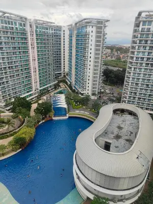 an aerial view of a building in front of tall buildings at Azure Urban Resort residence's Staycation by angkol limo in Manila