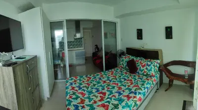 a bedroom with a bed with a flowered blanket at Azure Urban Resort residence's Staycation by angkol limo in Manila