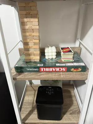 a shelf with books and other items on it at The Tropical Haven at Shore in Manila