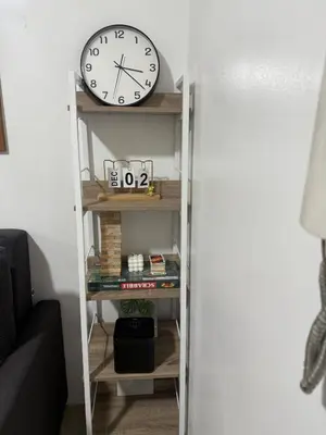 a clock sitting on a shelf next to a door at The Tropical Haven at Shore in Manila