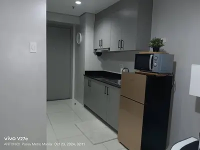 a kitchen with a microwave on top of a refrigerator at Modern 1BRH Condotel Stunning City ViewSea Views in Manila