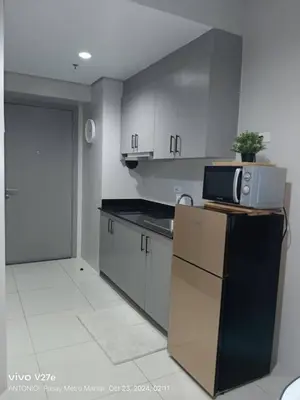a kitchen with a refrigerator and a microwave at Modern 1BRH Condotel Stunning City ViewSea Views in Manila