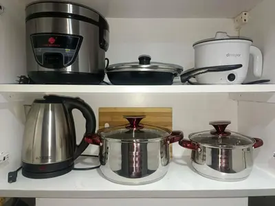 two pots and pans sitting on a stove in a kitchen at Modern 1BRH Condotel Stunning City ViewSea Views in Manila