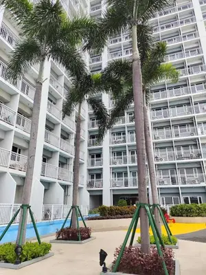 a cat walking in front of a building with palm trees at Modern 1BRH Condotel Stunning City ViewSea Views in Manila