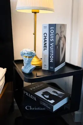 a table with a lamp and a box on it at Calme Corner Azure Urban Residences Maldives Tower in Manila