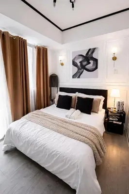 a bedroom with a large bed with white sheets and pillows at Calme Corner Azure Urban Residences Maldives Tower in Manila