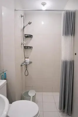 a bathroom with a shower and a toilet at Calme Corner Azure Urban Residences Maldives Tower in Manila