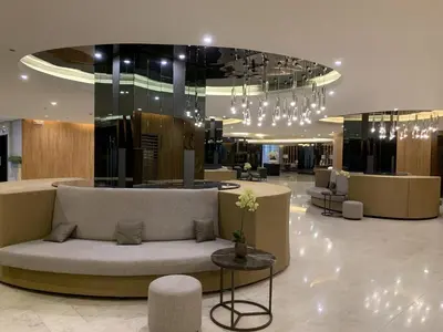 a lobby with a couch in the middle of a building at Le Trevi Suite at MOA Pasay Staycation in Manila