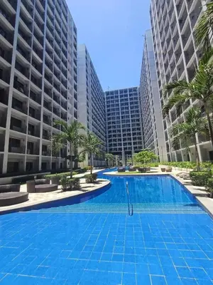 a large swimming pool in front of tall buildings at Le Trevi Suite at MOA Pasay Staycation in Manila