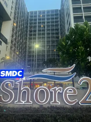 a sign that reads slore in front of buildings at Le Trevi Suite at MOA Pasay Staycation in Manila