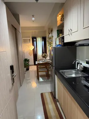 a kitchen with a sink and a counter top at Luxe staycation by Joy at Charm Residence Cainta in Manila