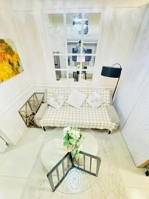 a living room with a couch and a table at Affordable Airport Staycation SMDC Field Residence in Manila