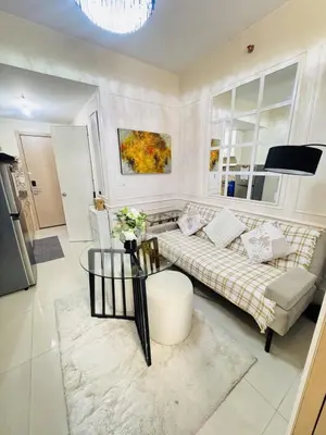 a living room with a couch and a table at Affordable Airport Staycation SMDC Field Residence in Manila