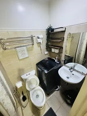 a bathroom with a toilet and a sink at Affordable Airport Staycation SMDC Field Residence in Manila