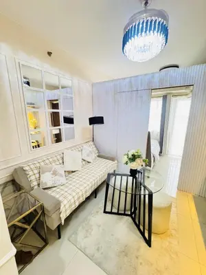 a living room with a couch and a table at Affordable Airport Staycation SMDC Field Residence in Manila