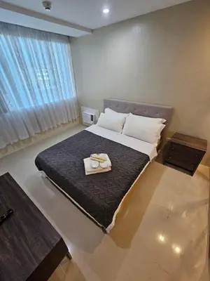 a bedroom with a bed with two towels on it at Casa Rosie in Seibu Tower - homey 1BR near BGC High Street in Manila