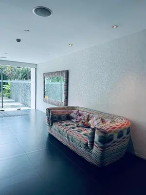 a living room with a couch in a room at Pahinga Luxury Stays in Manila
