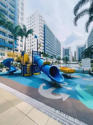 a playground with a slide in a city at NEAR SMX, MOA Sea Residence Condotel in Manila