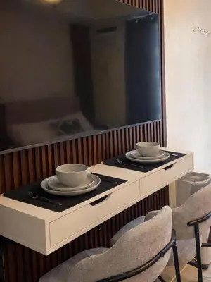 a table with two chairs and two bowls on it at Maison Inea in Manila