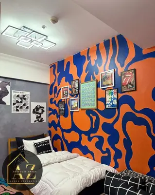 a bedroom with a bed and a painting on the wall at Azure Staycation by Adie Luxe Haven in Manila