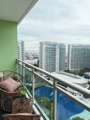 a balcony with a chair and a view of a city at Azure Staycation by Adie Luxe Haven in Manila