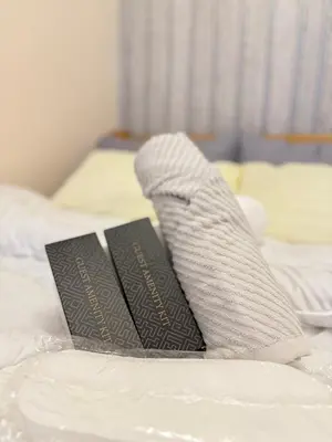 two books sitting on top of a bed at Azure Staycation by Adie Luxe Haven in Manila