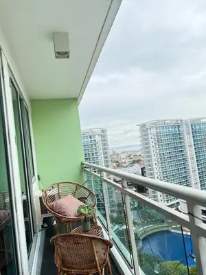 a balcony with two chairs and a view of a city at Azure Staycation by Adie Luxe Haven in Manila
