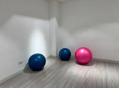 three balls sitting on the floor in a room at Spacious 1-BR Condo near BGC w Pool and Gym in Manila