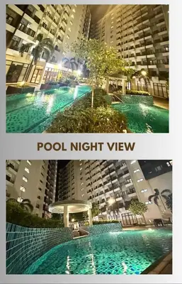 a picture of a pool in a city at night at MCStaycation at Spring Residence Near Airport in Manila